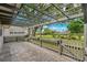 An outdoor patio with stone pavers features a pergola and a charming white picket fence at 1447 Kingfish Ln, Winter Haven, FL 33884