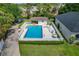 Aerial view of the fenced pool, featuring a covered patio and ample lounging space at 1447 Kingfish Ln, Winter Haven, FL 33884