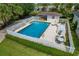 Beautiful aerial view of the backyard pool, enclosed by a privacy fence and mature trees at 1447 Kingfish Ln, Winter Haven, FL 33884