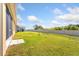 A spacious, well-manicured backyard with a white fence for privacy at 148 Emanuelle Dr, Winter Haven, FL 33884