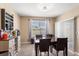 Dining room features an elegant light fixture, large windows, and neutral paint at 148 Emanuelle Dr, Winter Haven, FL 33884