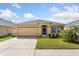 Charming one-story home featuring a well-manicured lawn, neutral exterior, and attached two-car garage at 148 Emanuelle Dr, Winter Haven, FL 33884
