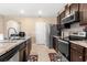 Eat-in kitchen showcasing dark wood cabinets, stainless steel appliances, and an undermount sink at 148 Emanuelle Dr, Winter Haven, FL 33884