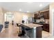 Eat-in kitchen featuring an island with breakfast bar, dark wood cabinets and stainless steel appliances at 148 Emanuelle Dr, Winter Haven, FL 33884