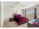 Main bedroom with a large window, ceiling fan, and a dark wood bed frame at 148 Emanuelle Dr, Winter Haven, FL 33884