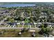 Aerial view captures waterfront living with boat access, lush landscaping, and serene lakeside setting at 1530 S Lake Howard Dr, Winter Haven, FL 33880