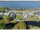 Aerial view of the property and neighborhood, showcasing its waterfront location on a lake at 1530 S Lake Howard Dr, Winter Haven, FL 33880