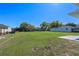 Expansive backyard featuring a large grassy area and a covered outdoor structure at 1530 S Lake Howard Dr, Winter Haven, FL 33880