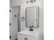 Bathroom featuring modern vanity with dark fixtures and large mirror at 1530 S Lake Howard Dr, Winter Haven, FL 33880