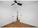 Bright bedroom with hardwood floors, ceiling fan, and a closet to enhance your living experience at 1530 S Lake Howard Dr, Winter Haven, FL 33880