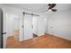 Bedroom featuring hardwood floors, ceiling fan, and sliding door leading to bathroom at 1530 S Lake Howard Dr, Winter Haven, FL 33880