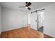 Bedroom featuring hardwood floors, ceiling fan, and sliding door leading to bathroom at 1530 S Lake Howard Dr, Winter Haven, FL 33880