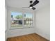 Bright room featuring a ceiling fan, large window, and natural light for a fresh, airy atmosphere at 1530 S Lake Howard Dr, Winter Haven, FL 33880