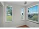 Bright bedroom with natural light, hardwood floors, and a tranquil view for rest and relaxation at 1530 S Lake Howard Dr, Winter Haven, FL 33880