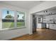 Sunlit dining area adjacent to modern kitchen with stainless steel appliances and tile backsplash at 1530 S Lake Howard Dr, Winter Haven, FL 33880