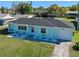 Charming single-story home with manicured lawn, paved walkway, and attached garage at 1530 S Lake Howard Dr, Winter Haven, FL 33880