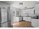 Modern kitchen featuring stainless steel appliances, black countertops, subway tile, and white cabinetry at 1530 S Lake Howard Dr, Winter Haven, FL 33880