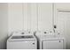 Laundry room featuring matching Samsung washer and dryer set and utility sink for convenient chores at 1530 S Lake Howard Dr, Winter Haven, FL 33880