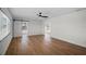 Spacious living room featuring modern sliding barn door, ceiling fan, and wood laminate flooring at 1530 S Lake Howard Dr, Winter Haven, FL 33880