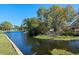 Waterfront scene with calm water and a partially visible concrete retaining wall along the edge at 1530 S Lake Howard Dr, Winter Haven, FL 33880
