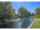Scenic waterfront view showcasing calm water and lush greenery along the shoreline at 1530 S Lake Howard Dr, Winter Haven, FL 33880
