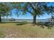 Picturesque waterfront featuring a lake, mature trees, and a serene view of a gazebo at 1530 S Lake Howard Dr, Winter Haven, FL 33880