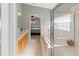 Bathroom featuring a tub, a glass-enclosed shower, and a single sink vanity at 1822 Nicaragua Way, Winter Haven, FL 33881