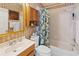 Bathroom featuring a shower-tub combo with a shower curtain, and wood vanity at 1822 Nicaragua Way, Winter Haven, FL 33881