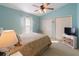 Comfortable bedroom with soft blue walls, ceiling fan, and double closets at 1822 Nicaragua Way, Winter Haven, FL 33881