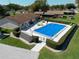 Overhead shot of a community pool with lounge chairs and a secure enclosure for resident enjoyment at 1822 Nicaragua Way, Winter Haven, FL 33881