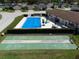 Aerial view of the community pool and shuffleboard courts in a well-maintained neighborhood at 1822 Nicaragua Way, Winter Haven, FL 33881