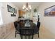 Inviting dining area featuring a dark wood table, chandelier, and tropical-themed decor at 1822 Nicaragua Way, Winter Haven, FL 33881