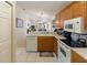 Functional kitchen with oak cabinets, white tile countertops, and ample lighting at 1822 Nicaragua Way, Winter Haven, FL 33881