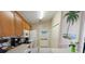 Bright kitchen with white appliances, oak cabinets, and a palm tree mural at 1822 Nicaragua Way, Winter Haven, FL 33881