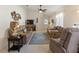 Cozy living room with plush seating, ceiling fan, and neutral carpet at 1822 Nicaragua Way, Winter Haven, FL 33881