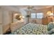 Bedroom featuring a bed with leaf pattern linens, a closet, a ceiling fan, and ample natural light at 200 El Camino Dr # 206, Winter Haven, FL 33884