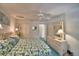 Cozy bedroom with a ceiling fan, closet, comfortable bed, and dresser at 200 El Camino Dr # 206, Winter Haven, FL 33884
