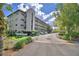 Spacious condo complex with multi-story levels, ample parking, and lush landscaping providing a serene atmosphere at 200 El Camino Dr # 206, Winter Haven, FL 33884