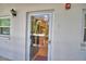 Inviting front door with glass insert allowing natural light, complemented by a wall-mounted lantern fixture at 200 El Camino Dr # 206, Winter Haven, FL 33884