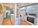 Bright kitchen with essential appliances connecting seamlessly to a cozy living area, creating an inviting atmosphere at 200 El Camino Dr # 206, Winter Haven, FL 33884
