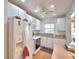 Charming kitchen with white appliances, cabinets, and laminate flooring with a lovely breakfast nook area at 200 El Camino Dr # 206, Winter Haven, FL 33884