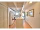 Bright kitchen featuring white cabinets, laminate floors, and a convenient breakfast bar, perfect for casual dining at 200 El Camino Dr # 206, Winter Haven, FL 33884