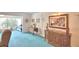 Comfortable living room with furnishings, blue carpet, and views through large windows at 200 El Camino Dr # 206, Winter Haven, FL 33884