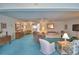 Bright living room with a ceiling fan, comfortable seating, and large windows for natural light at 200 El Camino Dr # 206, Winter Haven, FL 33884