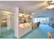 Bright living room featuring built-in shelving, a ceiling fan, and a view into other rooms at 200 El Camino Dr # 206, Winter Haven, FL 33884