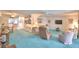 Spacious living room with built-in shelving, comfortable seating, and open access to the kitchen at 200 El Camino Dr # 206, Winter Haven, FL 33884