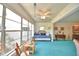 Sunroom with a daybed and furnishings, blue carpet, and windows offering lots of light at 200 El Camino Dr # 206, Winter Haven, FL 33884