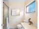 Well-lit bathroom with shower and tub, featuring a granite vanity top and decorative mirror at 205 Kilmer Ln, Winter Haven, FL 33884
