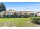 Charming single-story brick home with a well-maintained lawn and classic shutters on a sunny day at 205 Kilmer Ln, Winter Haven, FL 33884