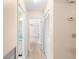 Hallway featuring terrazzo floors and access to other rooms in the house at 205 Kilmer Ln, Winter Haven, FL 33884